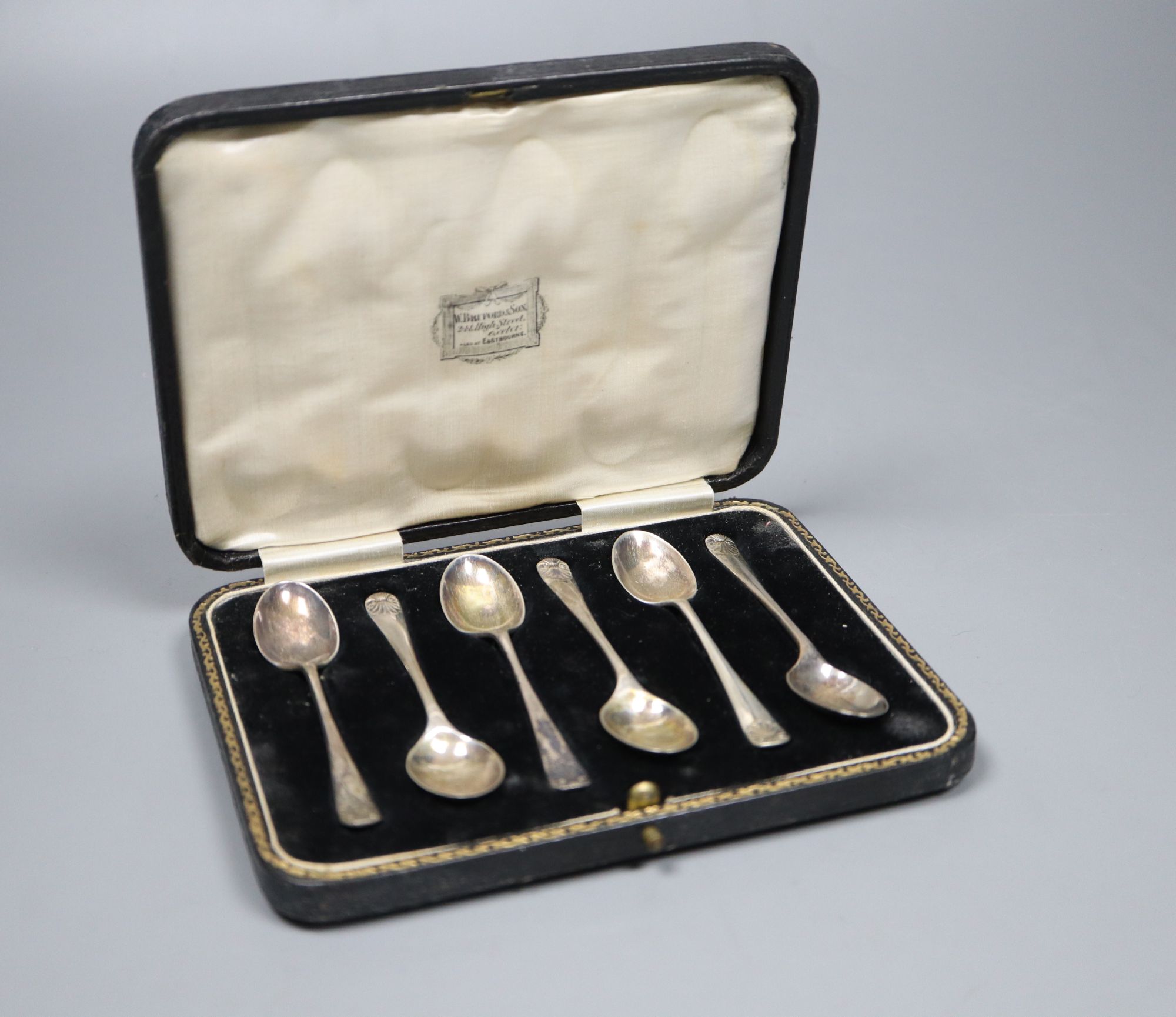A set of six George V silver coffee spoons with shell terminals, by Thomas Bradbury & Sons, cased.